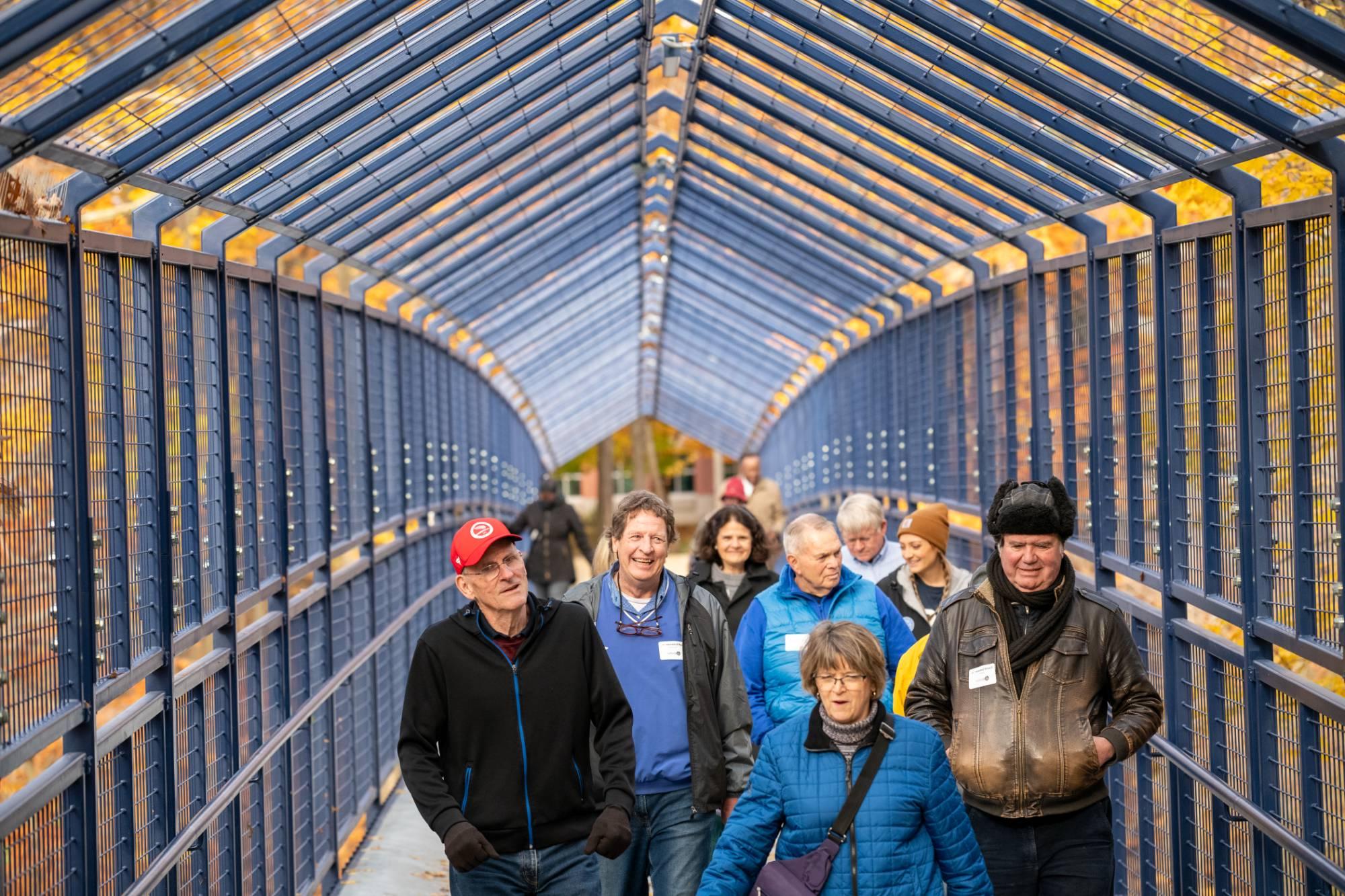 Alumni walking on Little Mac Bridge